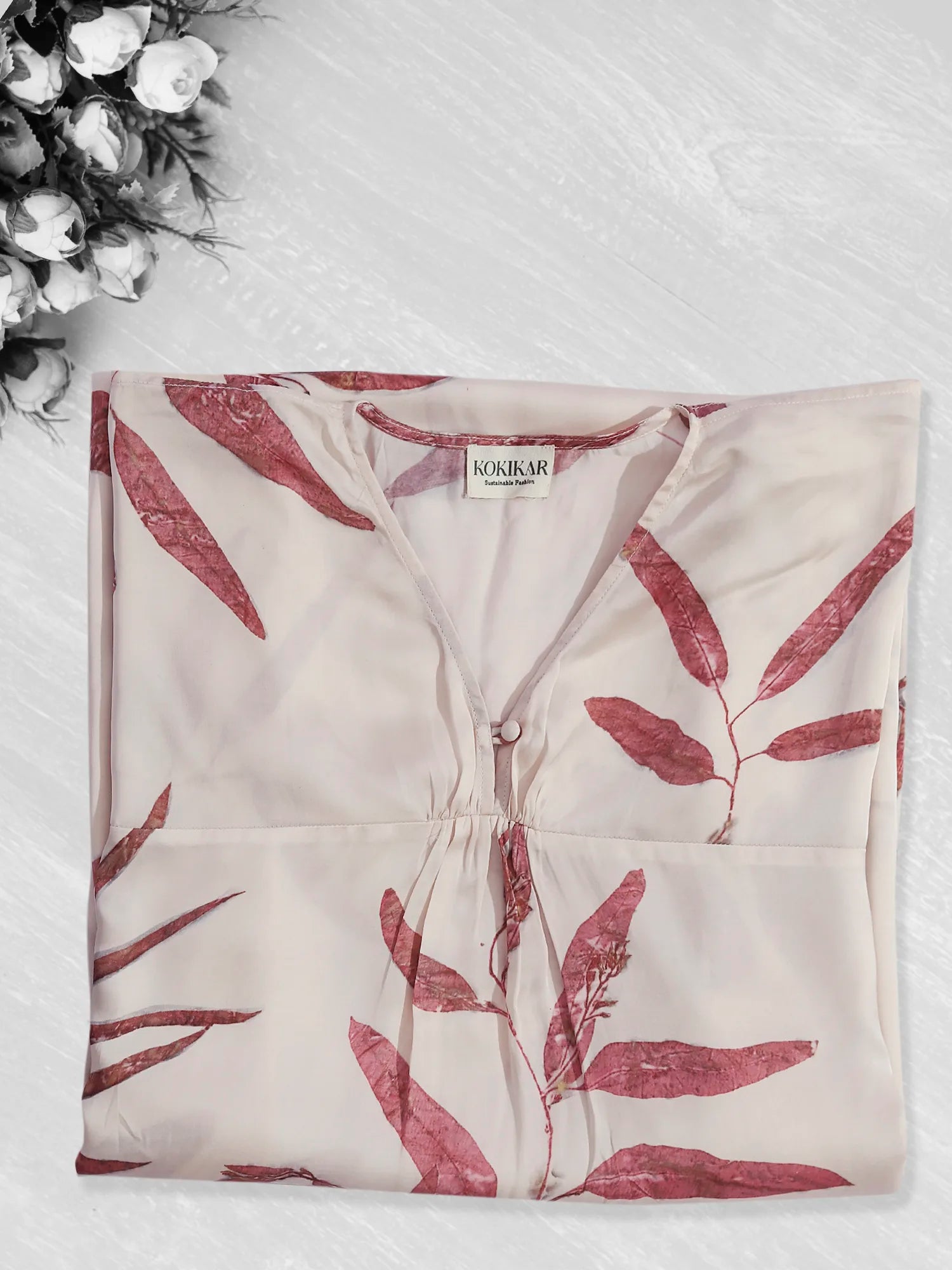 Red Eucalyptus ecoprinted kaftan folded on kokikar floor