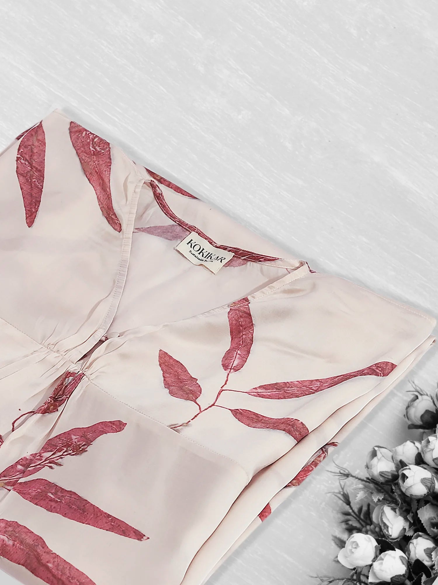 Red Eucalyptus ecoprinted kaftan folded on kokikar floor
