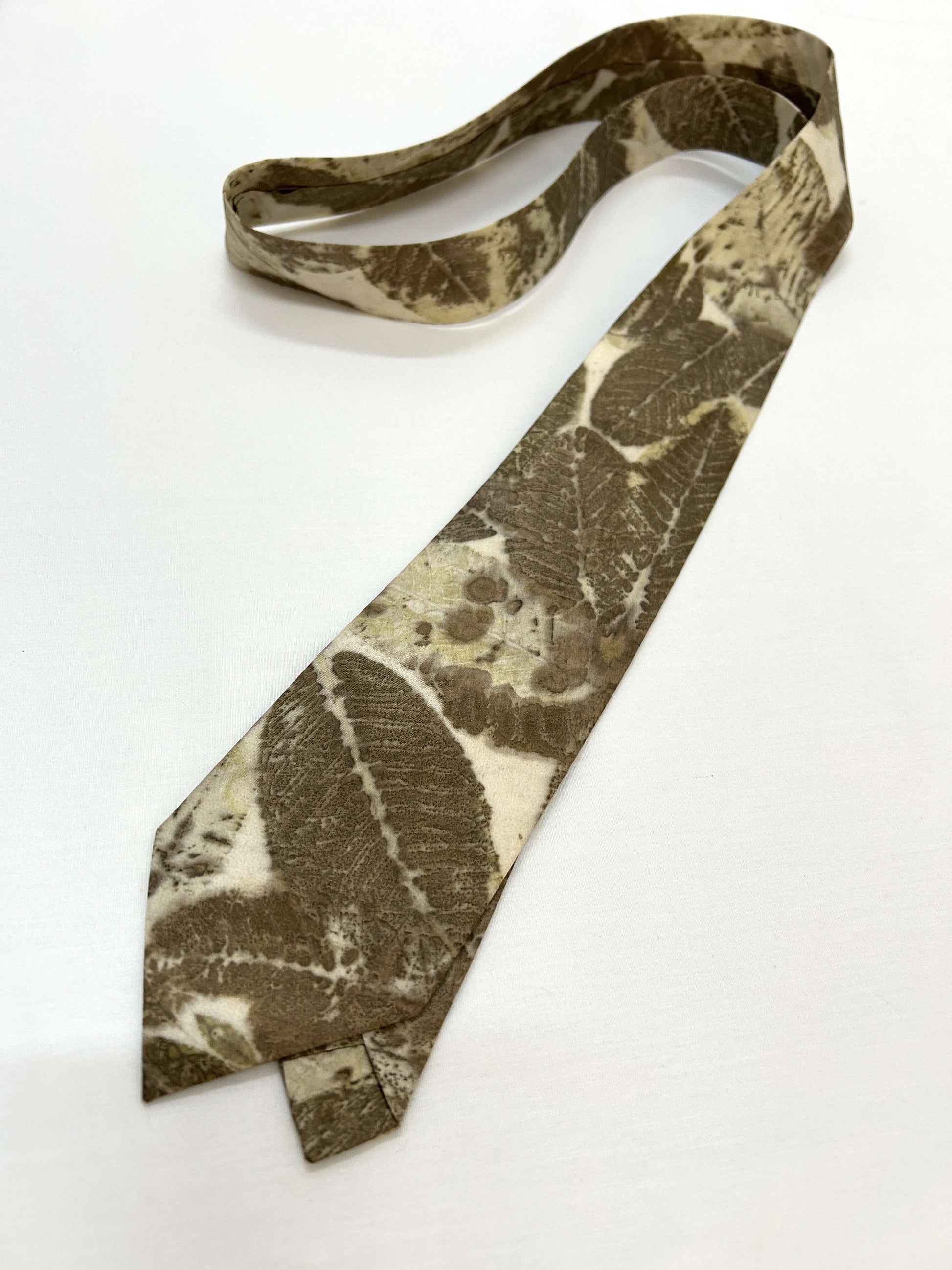 A green and beige ecoprinted tie