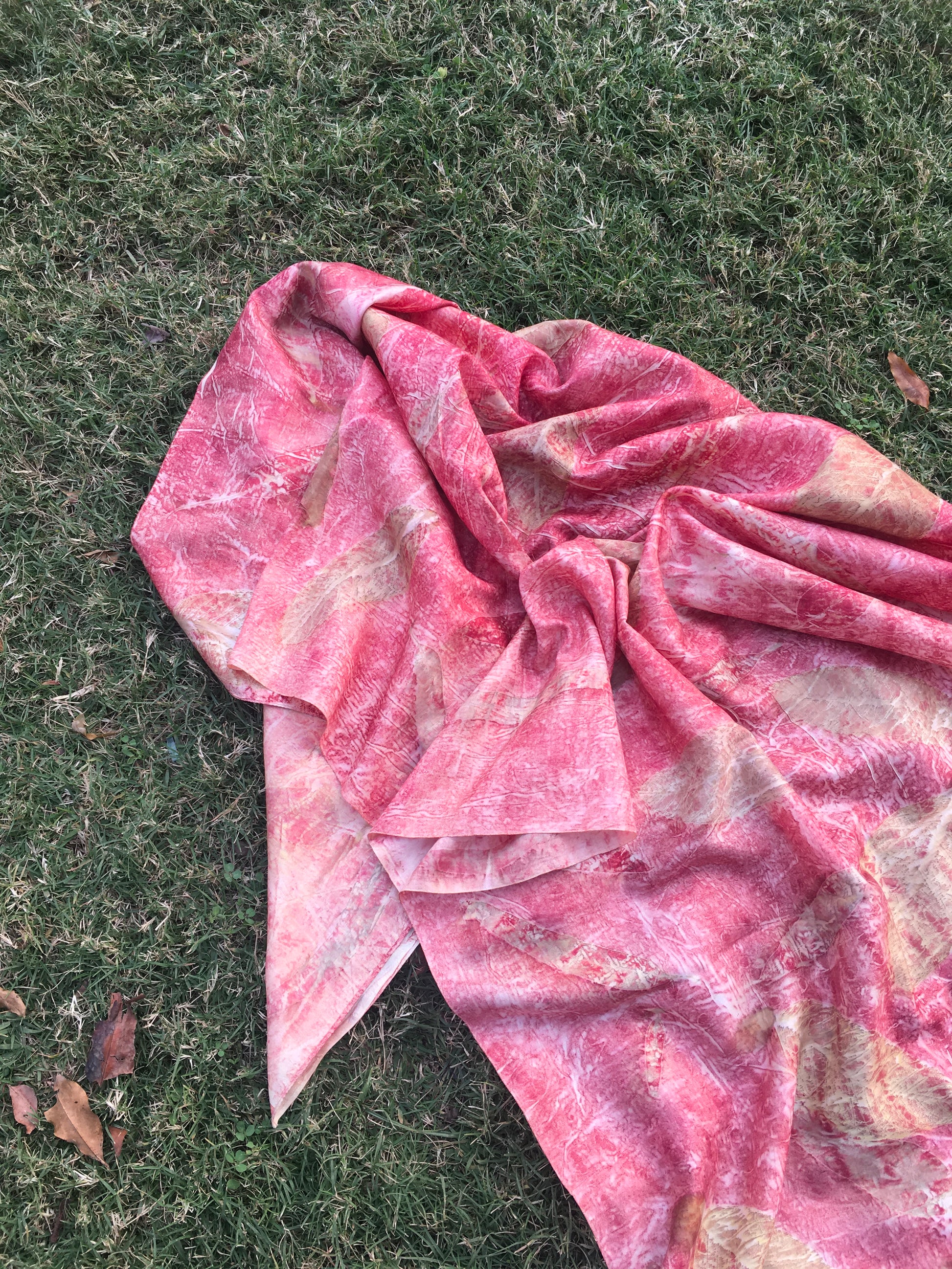 Handmade eco printed pure silk scarf with pink botanical leaf patterns created using natural dyes and sustainable eco printing techniques.
