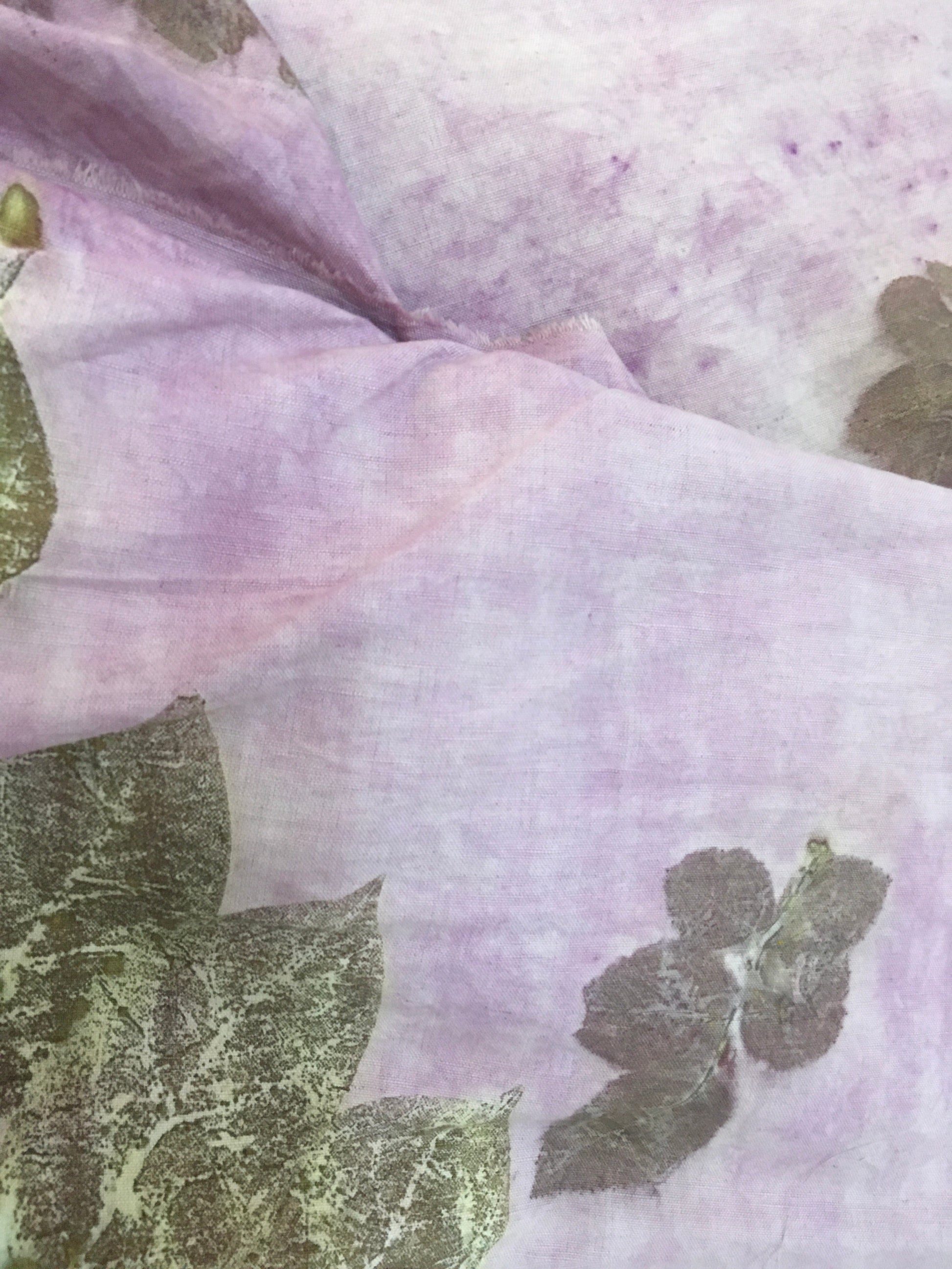 Purple fabric with ecoprinted leaf.
