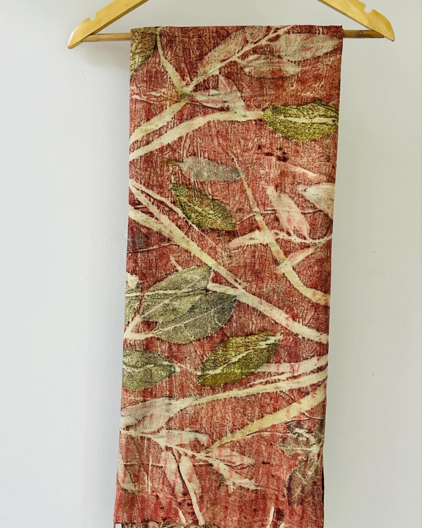 A hanging ecoprinted eri silk scarf.