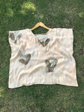 Kaftan Flared Top with small leaves on a grassy surface