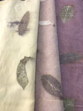 Three rolls of Linen Blend Handmade Ecoprinted Fabric with leaf patterns in different colors.