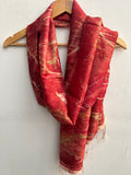 An ecoprinted red silk scarf