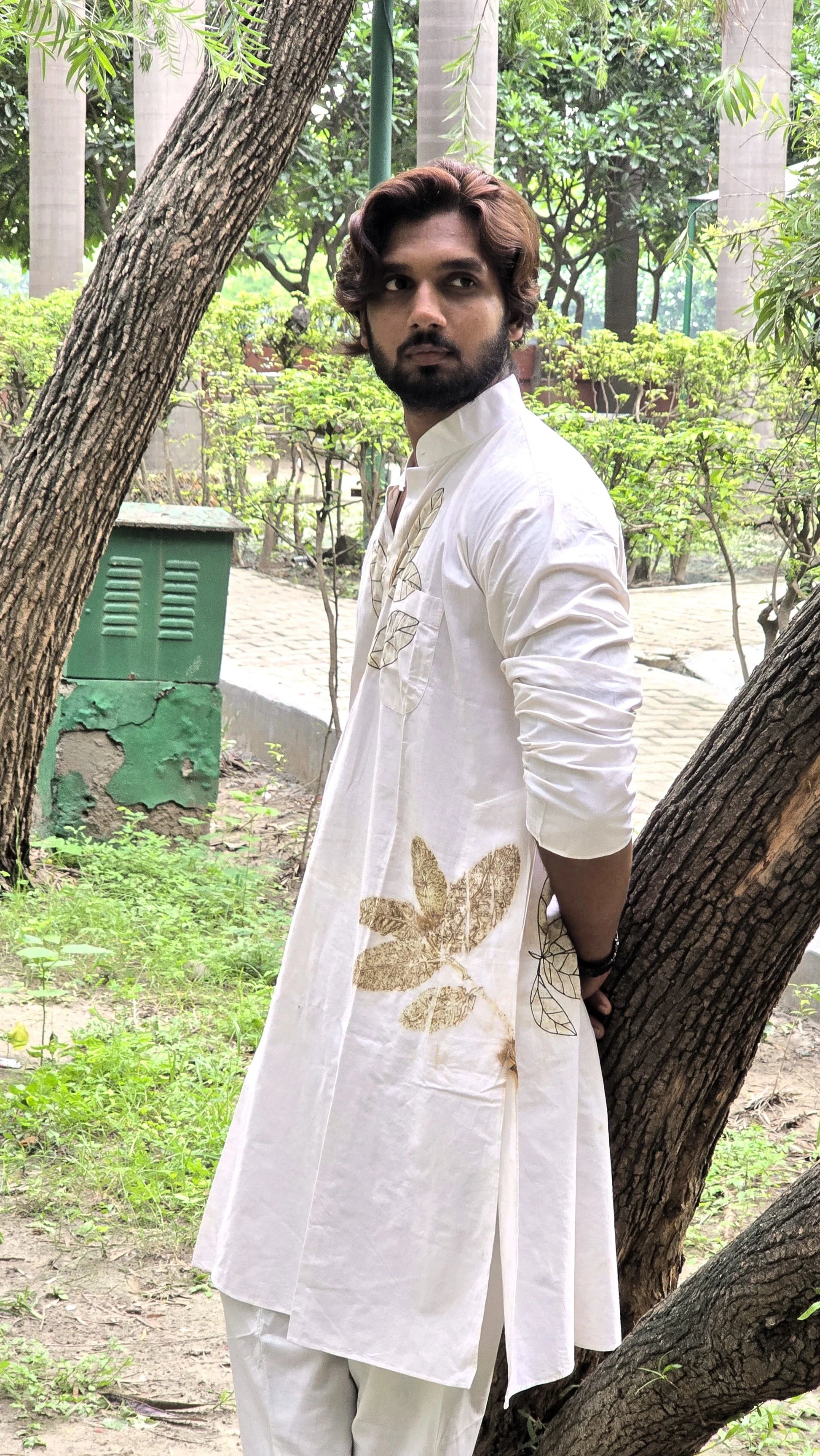 White Floral Threaded Cotton Long Kurta boy in front of kokikar tree