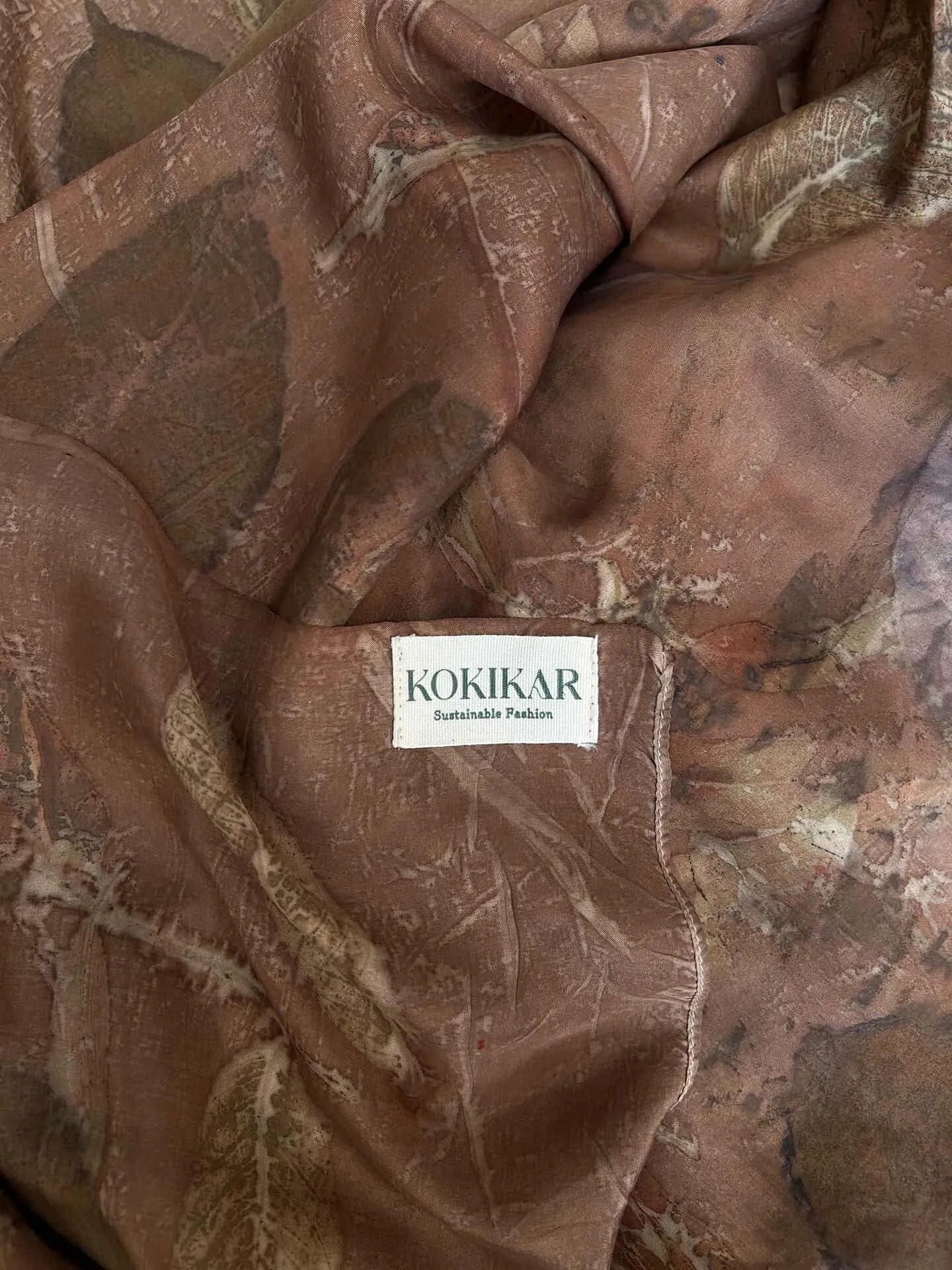 Brown Handcrafted pure silk scarf naturally dyed with catechu and eco printed with seasonal leaves and mixed botanical plants, featuring rich dark brown earthy tones and sustainable artisan craftsmanship.