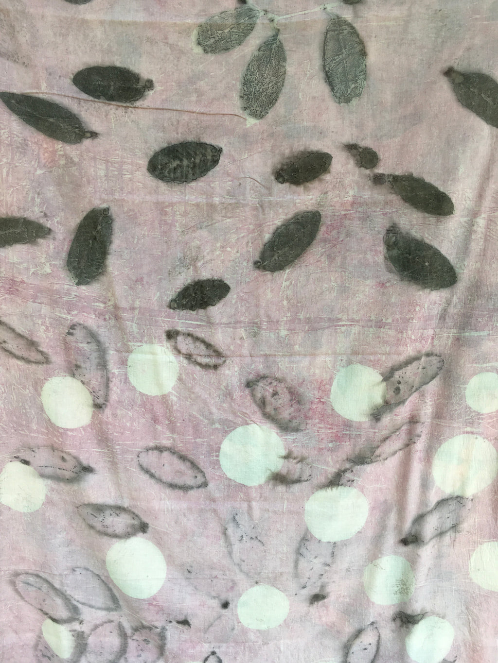 Textured mulmul cotton ecoprinted saree with leaf patterns and white dots on a pink background