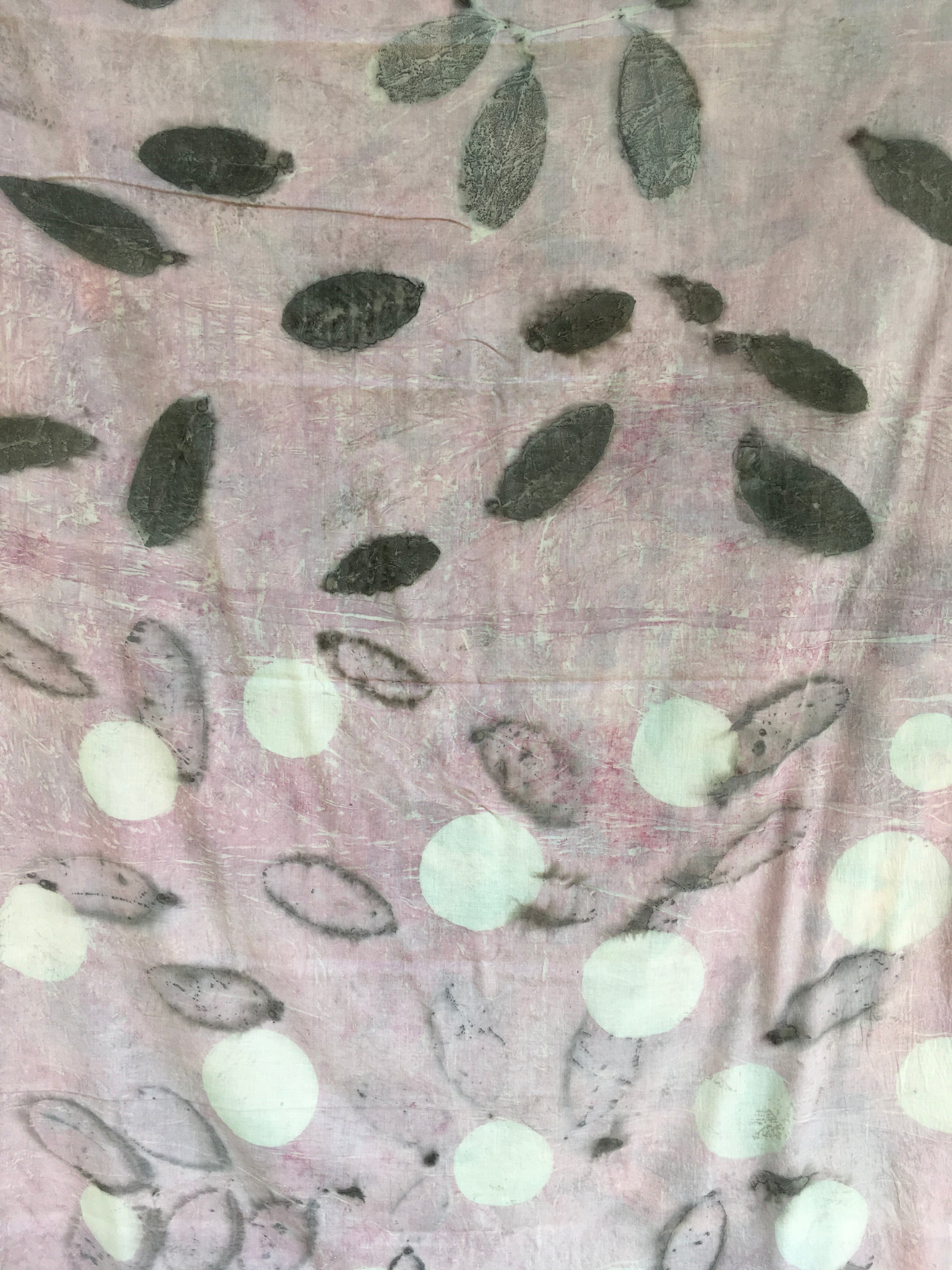Textured mulmul cotton ecoprinted saree with leaf patterns and white dots on a pink background