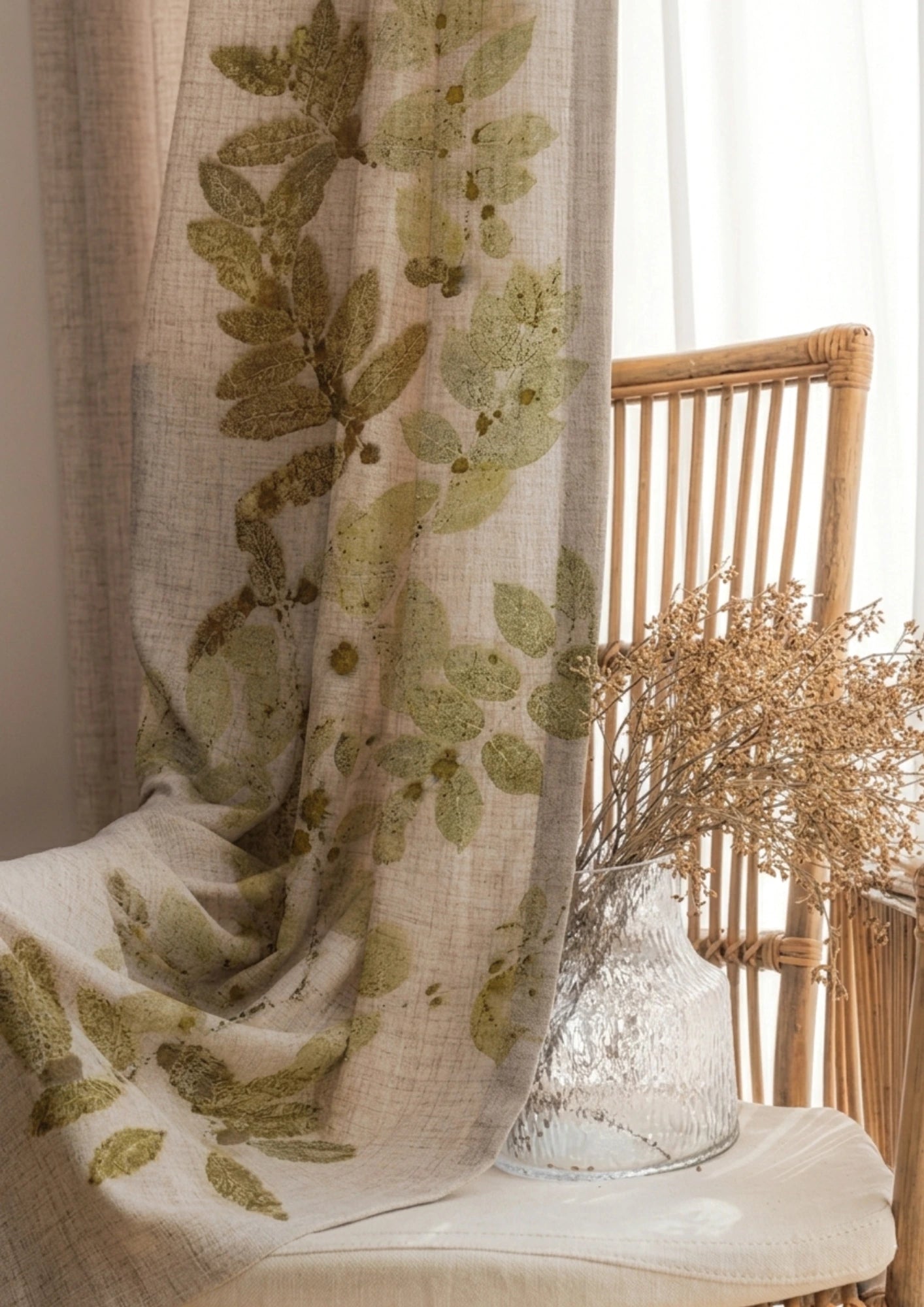 Decorative Botanical Breeze eco-printed linen curtain featuring natural leaf impressions on premium linen fabric, handcrafted sustainable window décor inspired by nature curtain with leaf pattern on a chair with a vase of dried flowers.