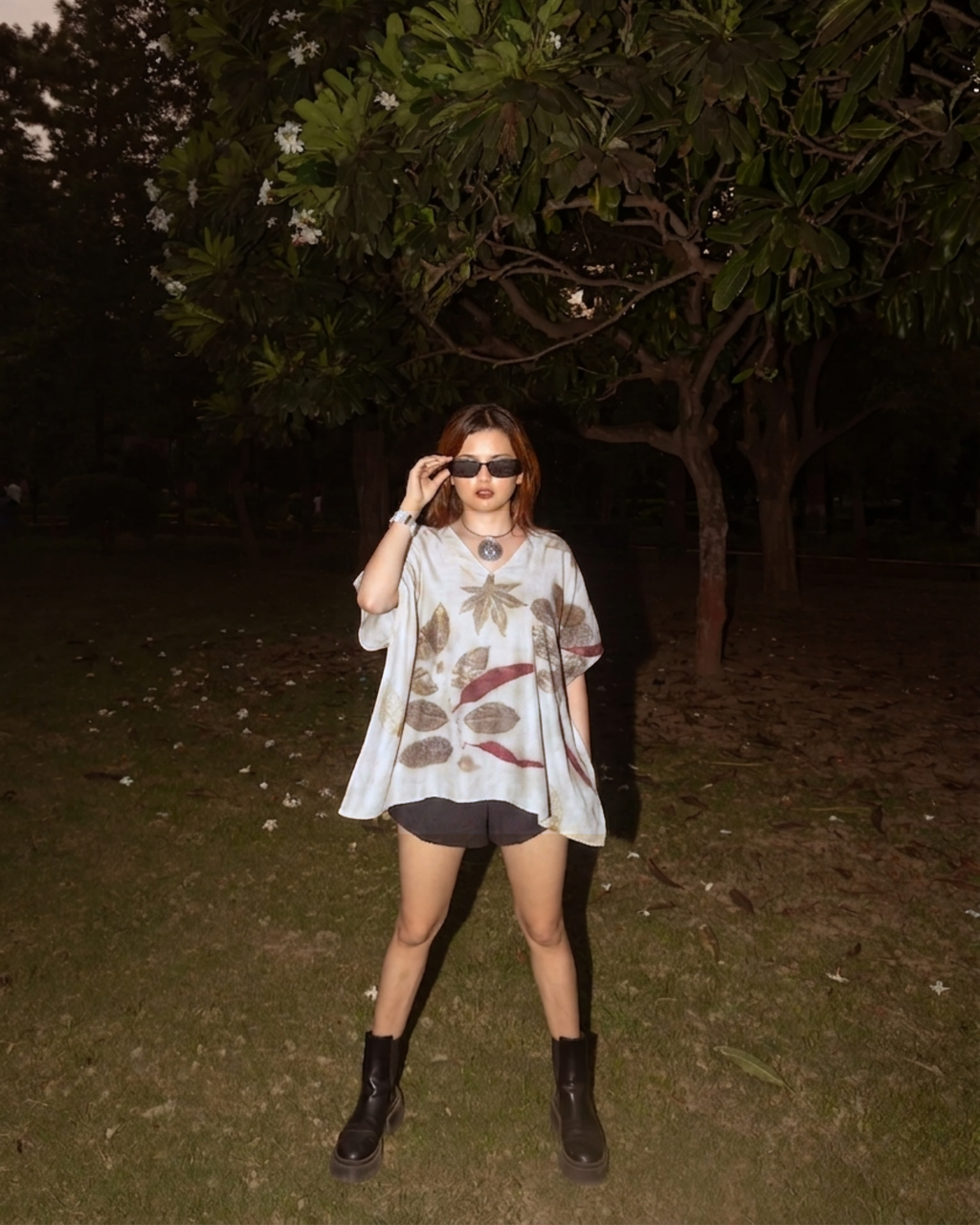 girl wearing a ecoprinted Kaftan Flared Top and black boots in a dark outdoor setting