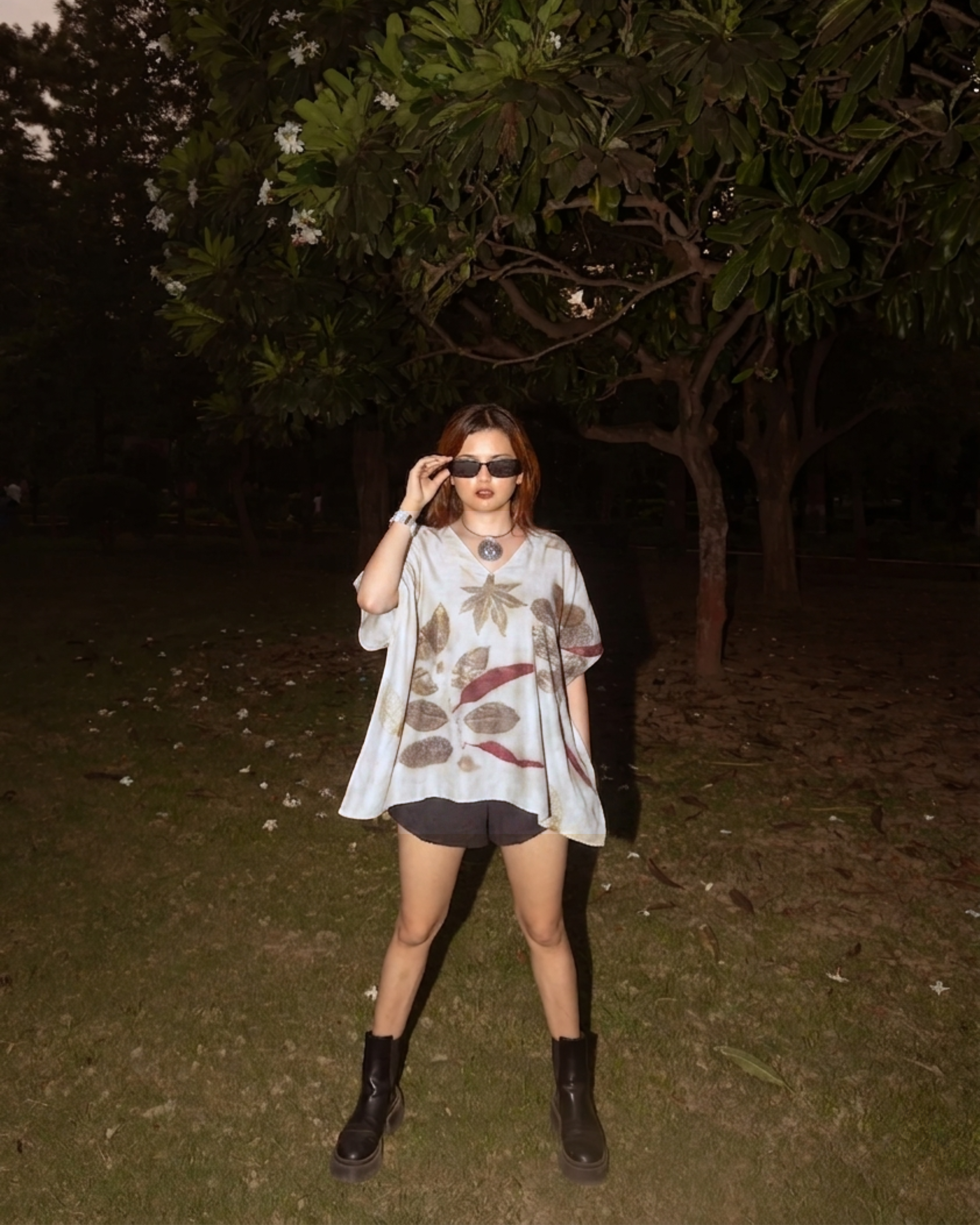 girl wearing a ecoprinted Kaftan Flared Top and black boots in a dark outdoor setting
