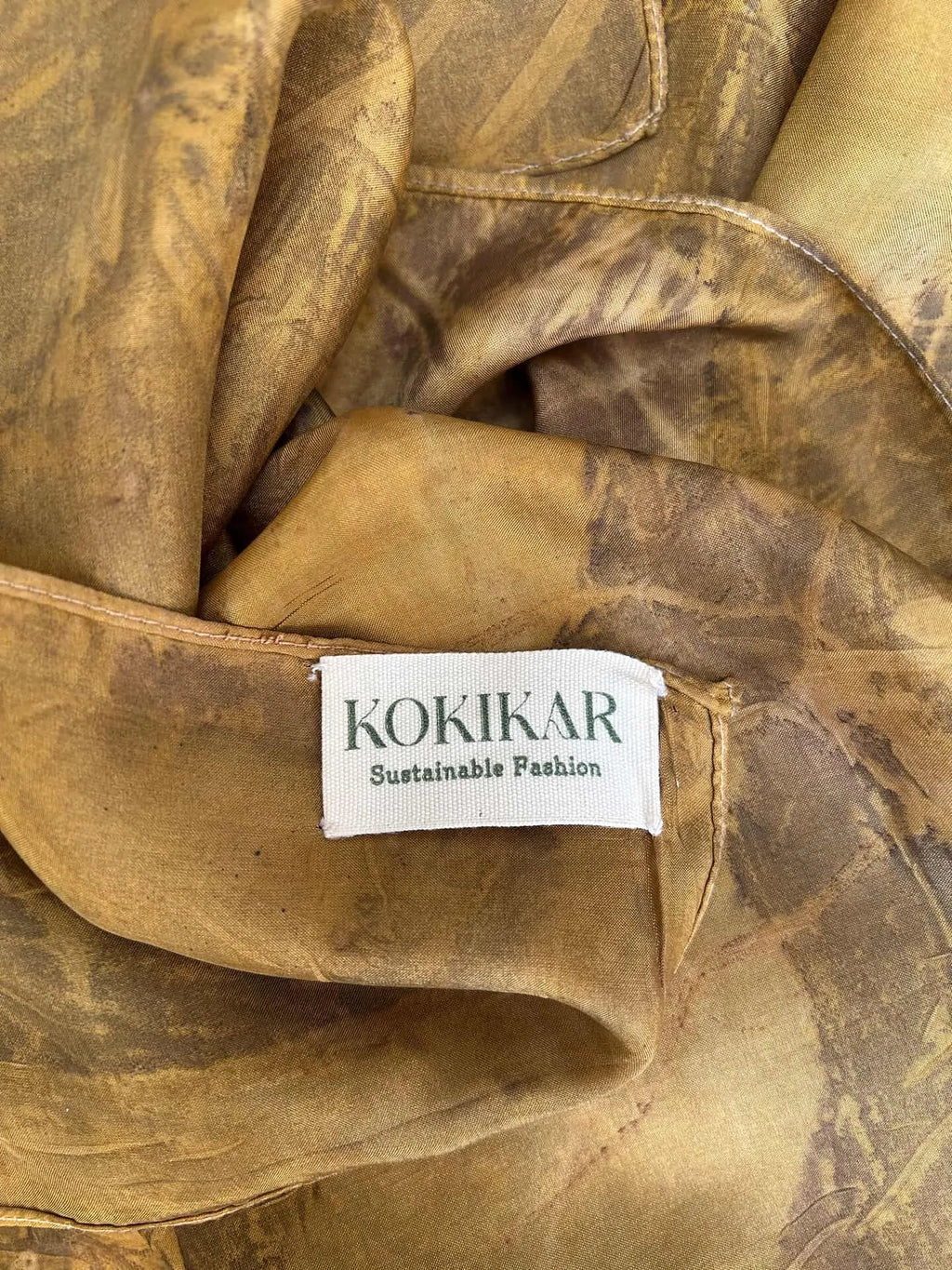 Sustainable eco printed pure silk scarf with jamun leaf patterns and natural marigold flower dye.