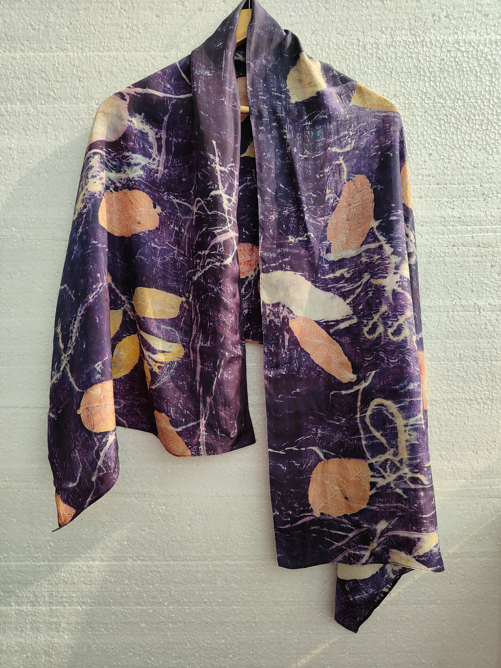 A logwood ecoprinted pure silk scarf  with seasonal leaves.