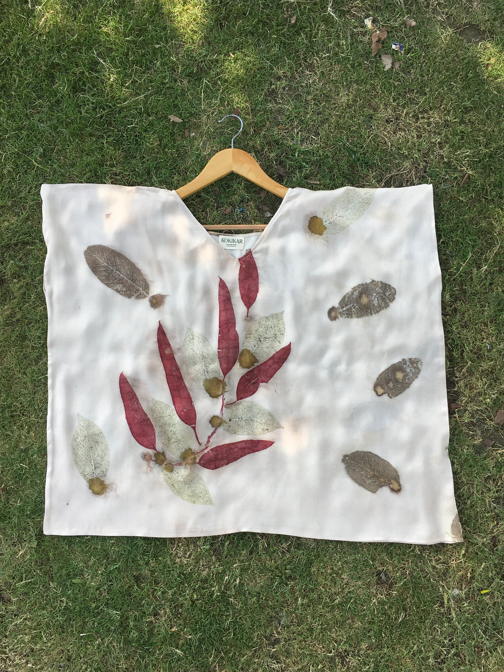 Kaftan Flared Top with leaf patterns on a grassy background