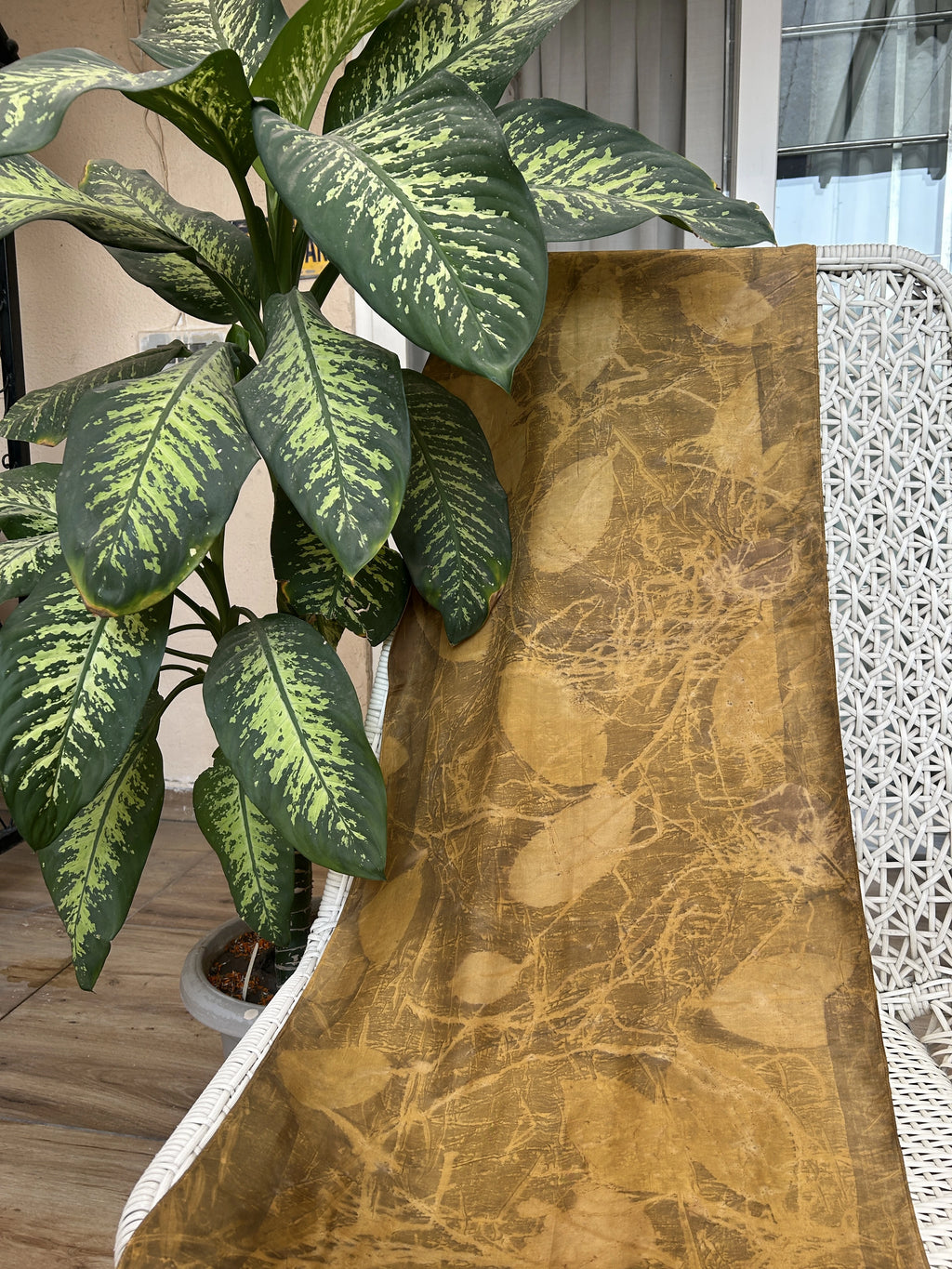 Golden pure silk scarf naturally dyed with marigold and eco printed with real jamun leaf impressions.