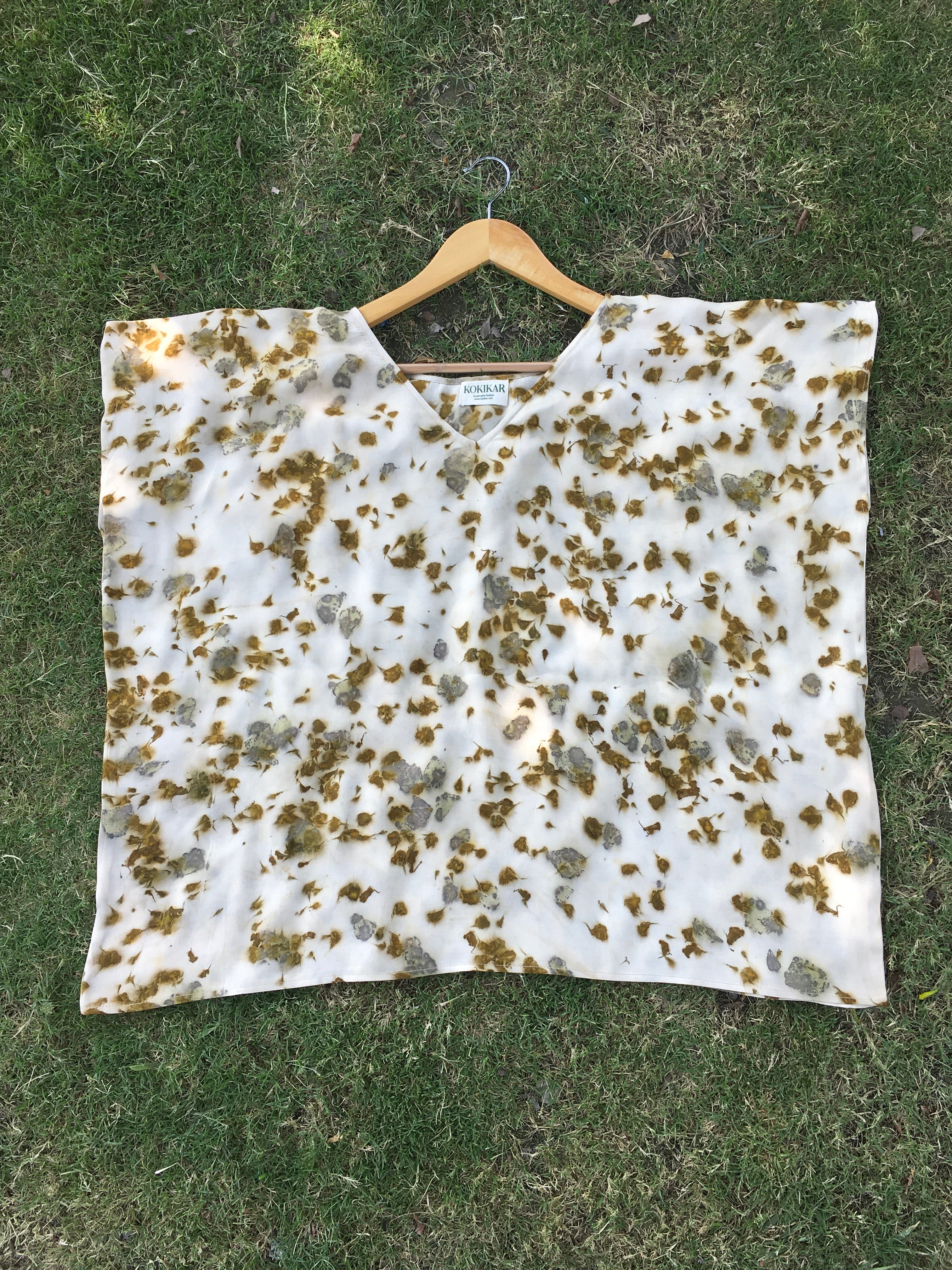 Kaftan Flared Top with marigold and rose petal dye on a grassy background