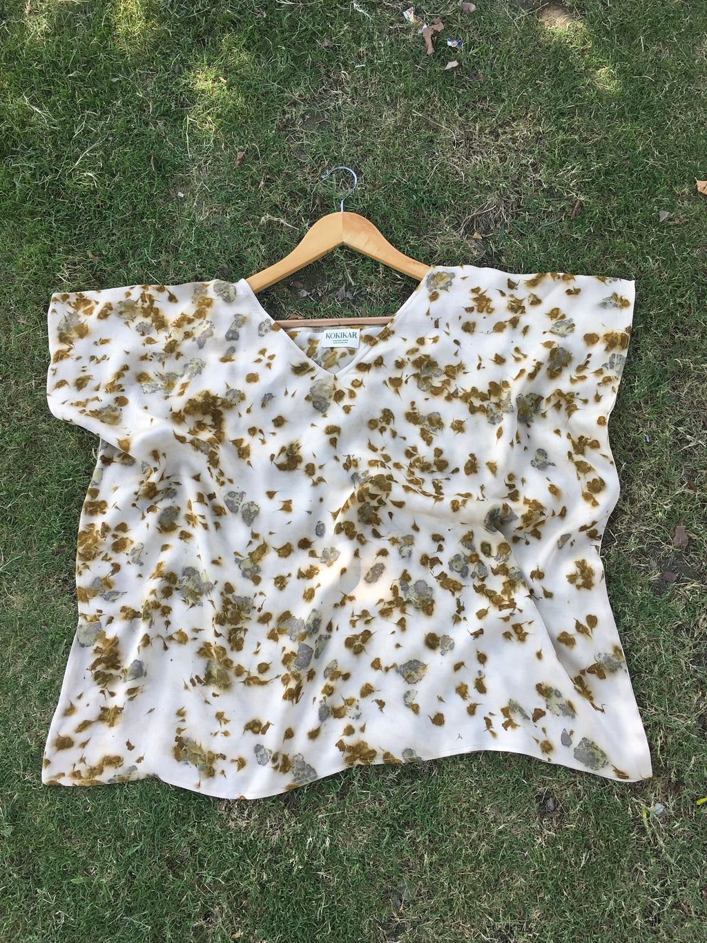Kaftan Flared Top with brown marigold spots on a grassy background