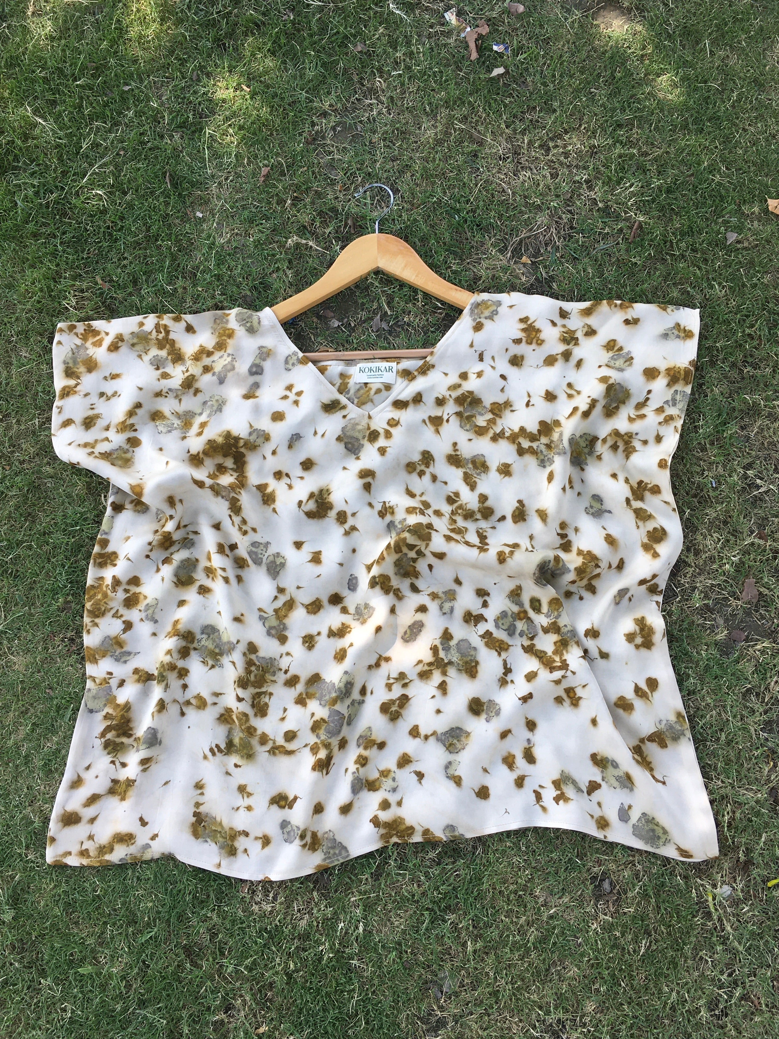 Kaftan Flared Top with brown marigold spots on a grassy background