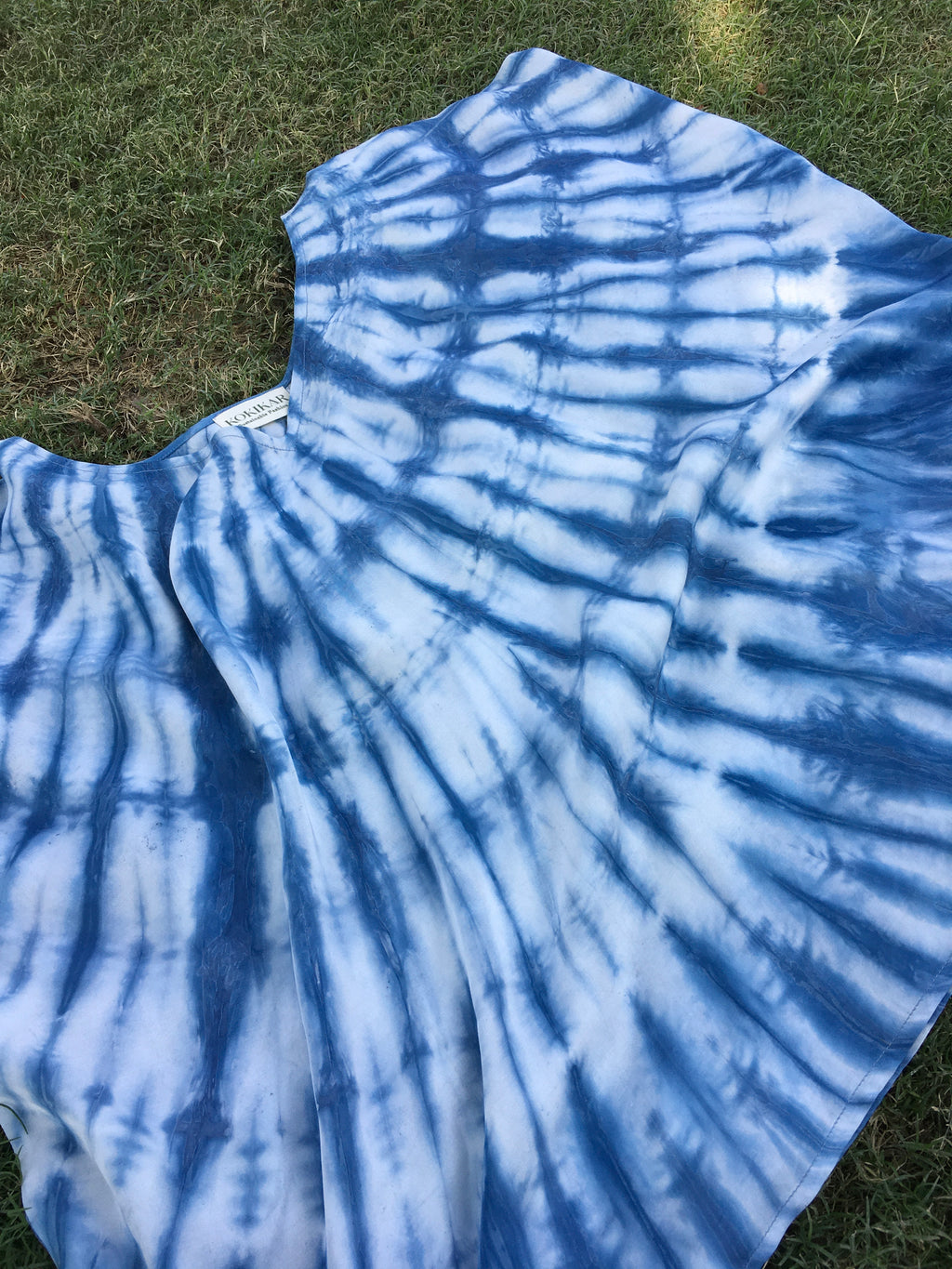 Blue tie-dye Kaftan Flared Top on a grassy background