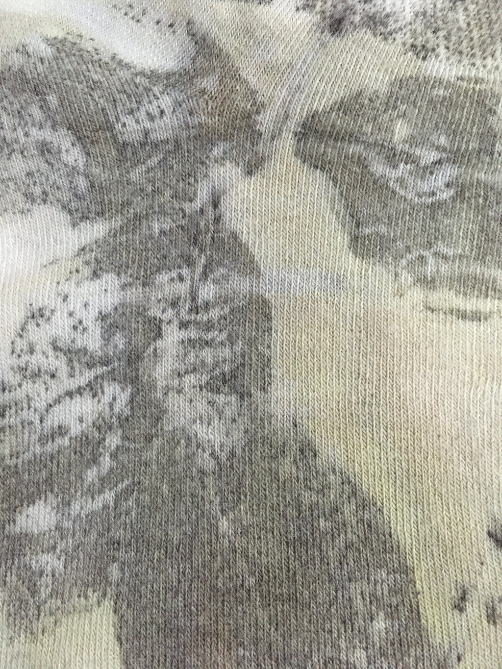 Close-up of Sustainable cotton socks with floral leaf print in earthy tones 