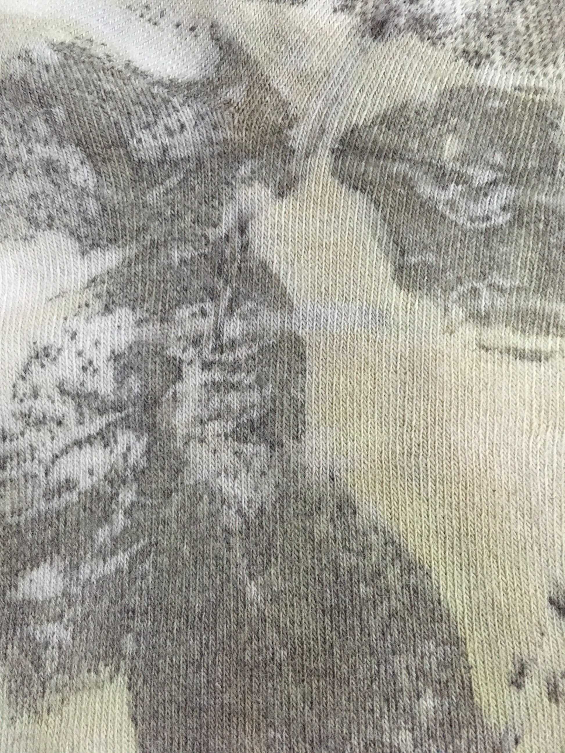 Close-up of Sustainable cotton socks with floral leaf print in earthy tones 