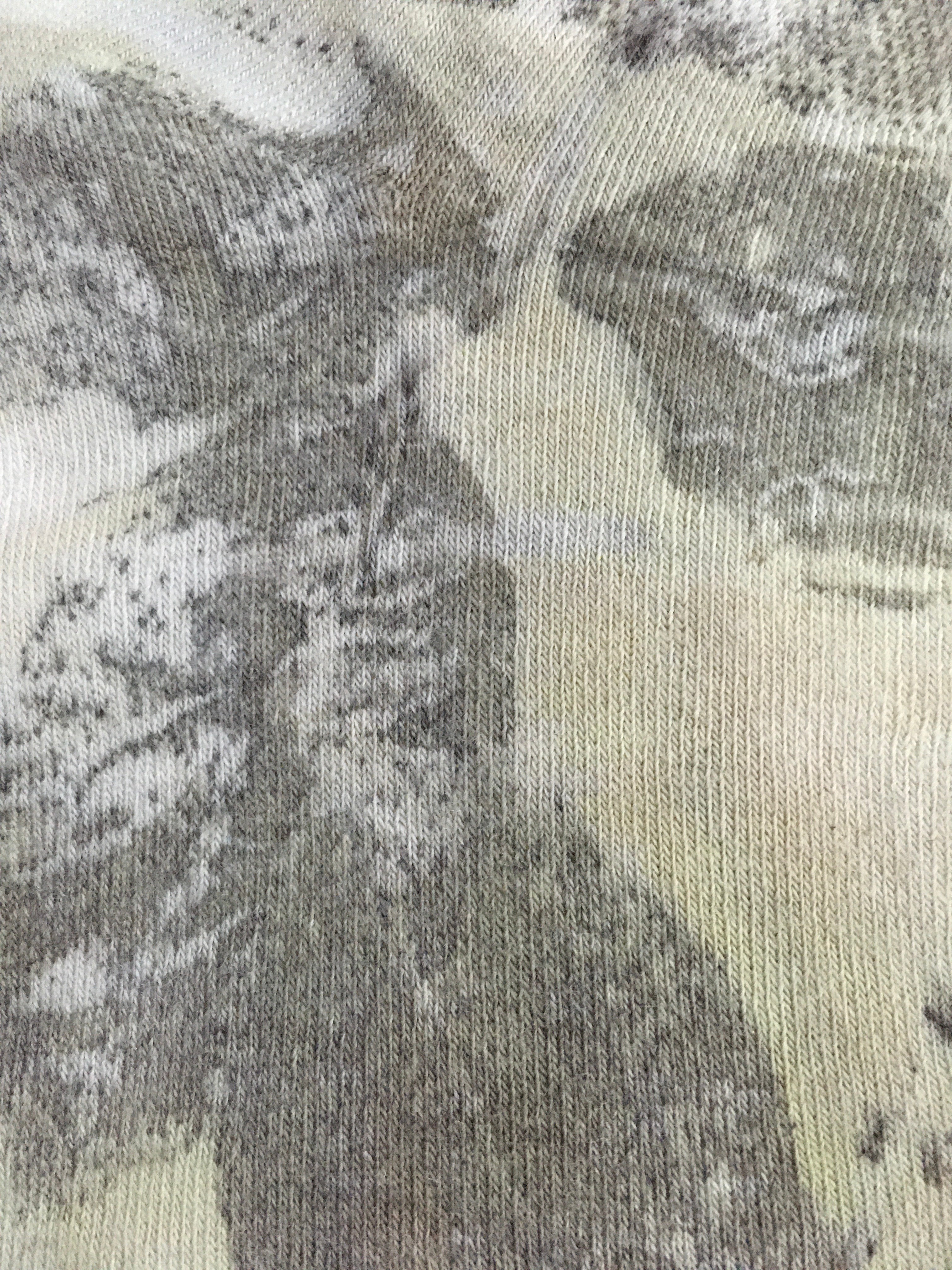 Close-up of Sustainable cotton socks with floral leaf print in earthy tones 