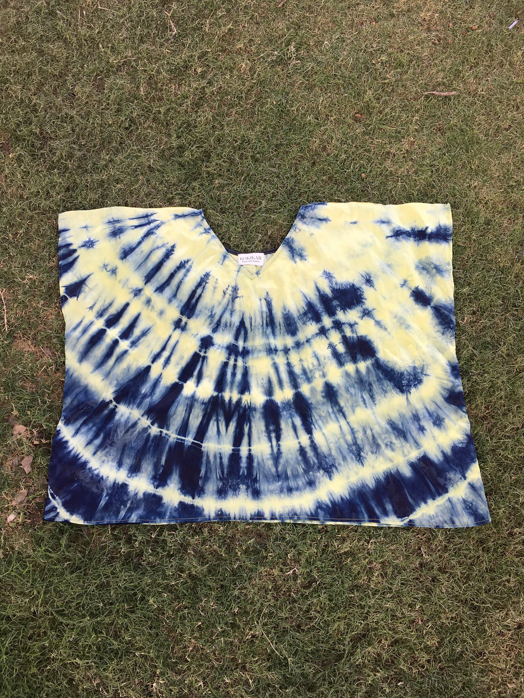Tie dye Kaftan Flared Top with blue and yellow pattern on a grassy background