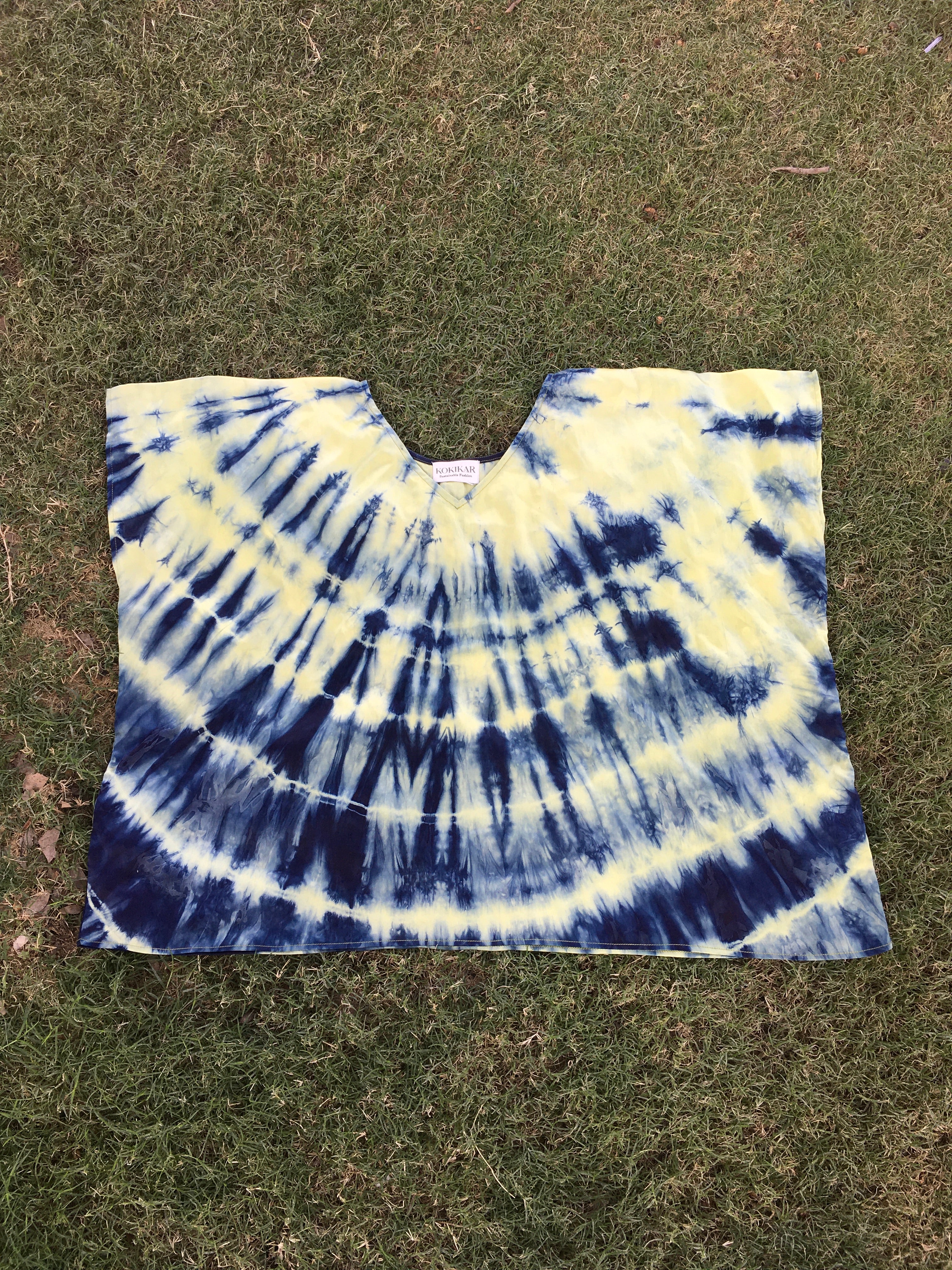 Tie dye Kaftan Flared Top with blue and yellow pattern on a grassy background