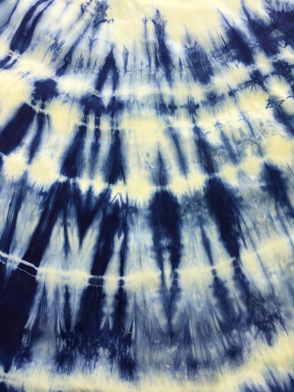 Tie dye pattern with blue and white colors on a Kaftan Flared Top fabric background