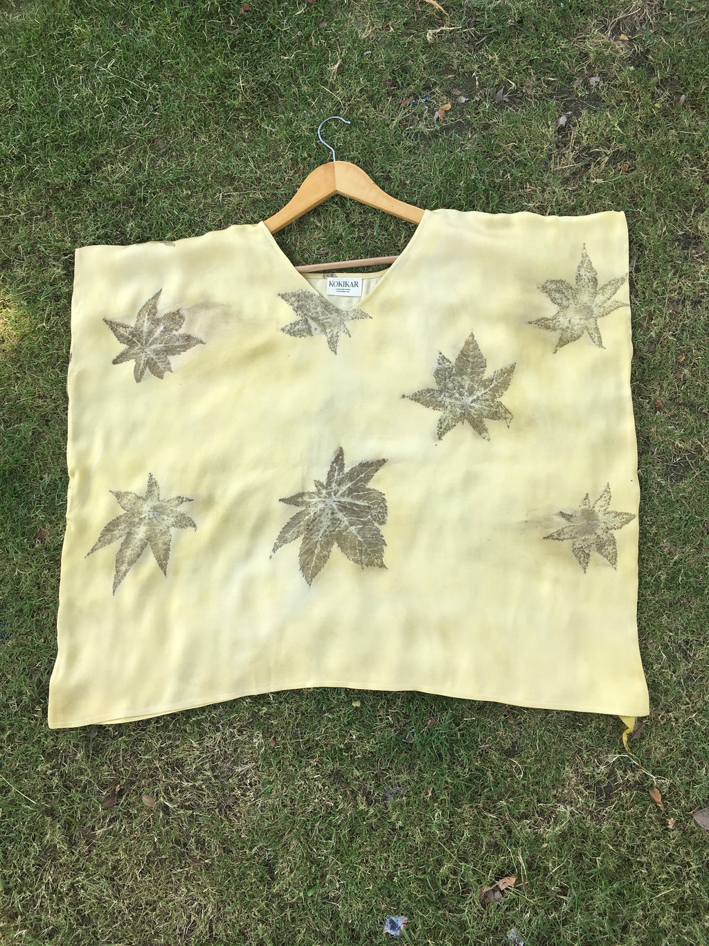 Yellow Kaftan Flared Top with leaf patterns on grass