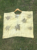 Yellow Kaftan Flared Top with leaf patterns on grass