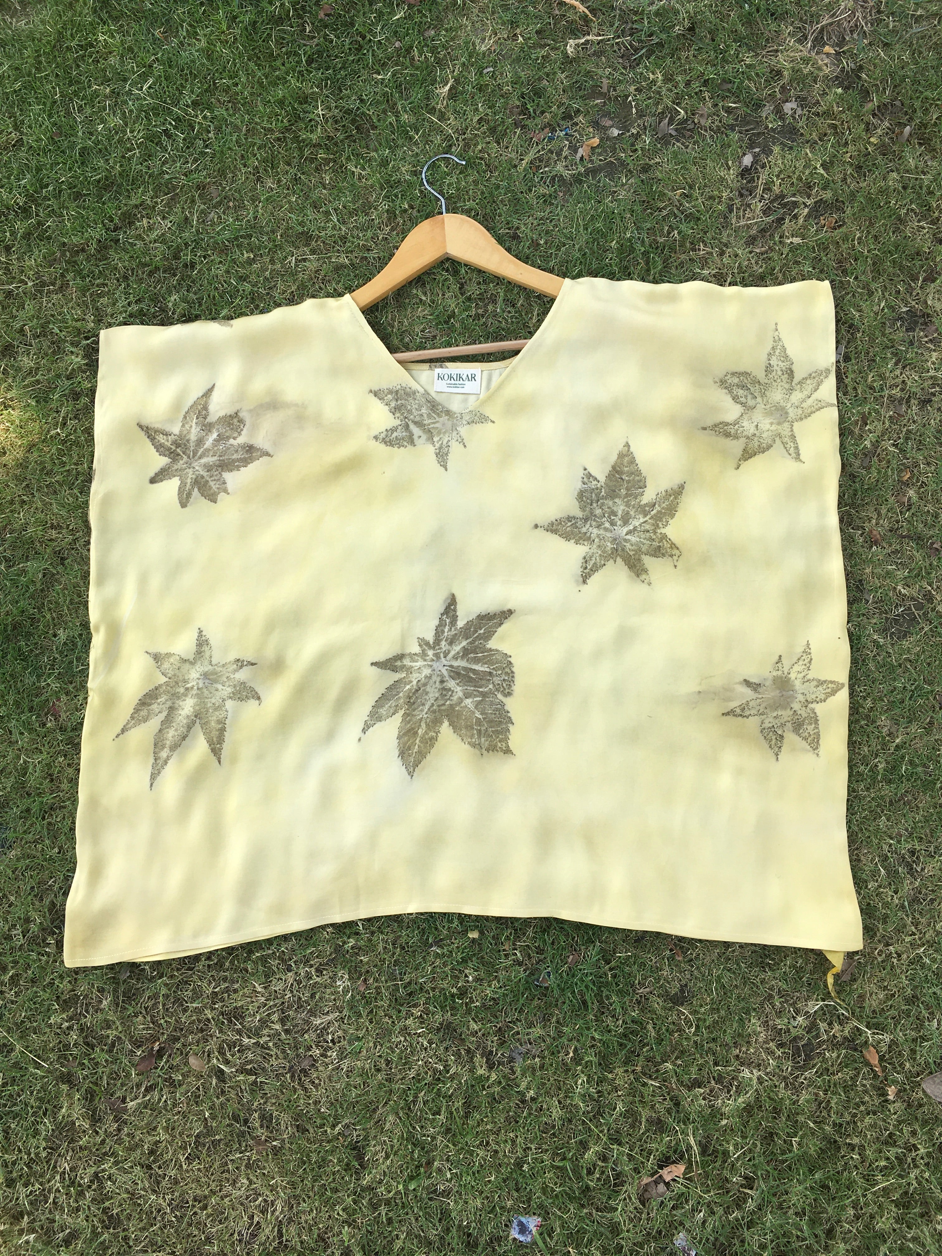 Yellow Kaftan Flared Top with leaf patterns on grass
